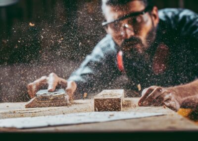 carpenter working with sawdust in air