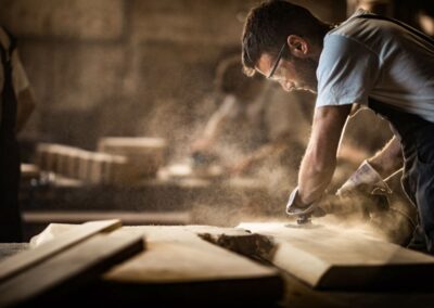 carpenter using sander on board