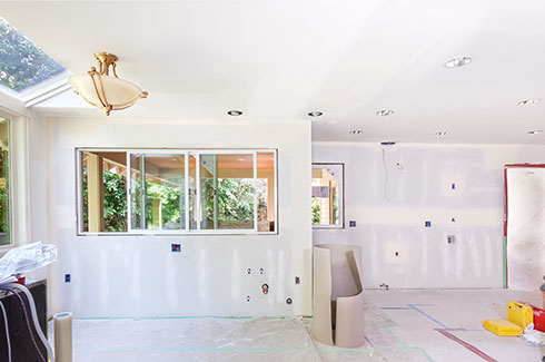 Interior remodeling with bare drywall and plumbing fitouts